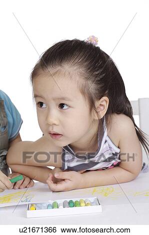 Close-up of little girl drawing and looking away View Large Photo Image Stock Photograph - Close-up of little girl drawing and looking away. Fotosearch