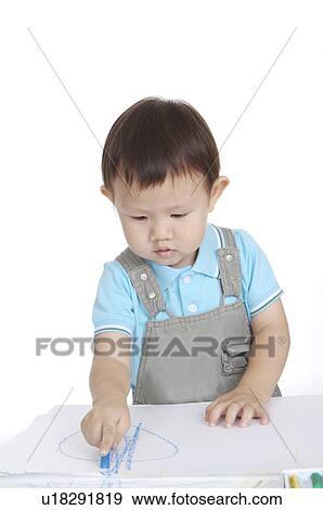 Stock Photo - Little boy drawing and looking down. Fotosearch