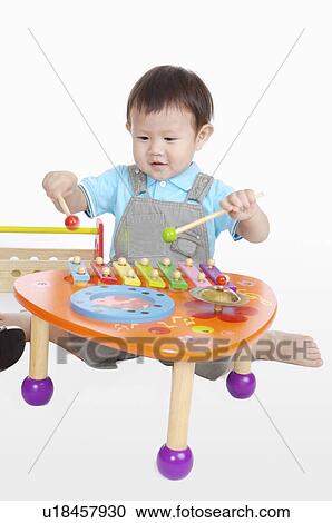 Little boy playing xylophone and smiling View Large Photo Image Stock Image - Little boy playing xylophone and smiling. Fotosearch
