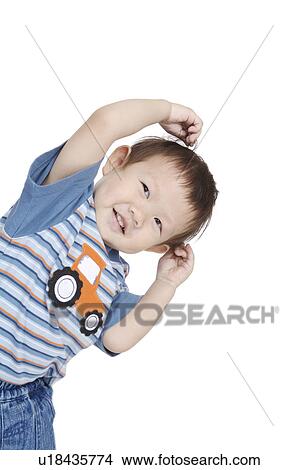 Picture - Little boy posing and looking away with smile. Fotosearch
