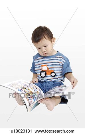 Little boy sitting and reading a book View Large Photo Image Stock Image - Little boy sitting and reading a book. Fotosearch