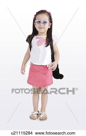 Picture - Little girl dressing up and looking away. Fotosearch