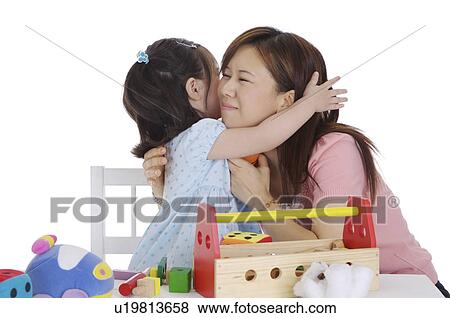 Little girl embracing young mother with smile View Large Photo Image Stock Photo - Little girl embracing young mother with smile. Fotosearch