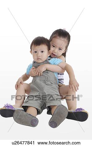 Little girl holding little boy and sitting together View Large Photo Image Stock Image - Little girl holding little boy and sitting together. Fotosearch