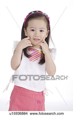 Little girl posing and looking at the camera with smile View Large Photo Image Picture - Little girl posing and looking at the camera with smile. Fotosearch