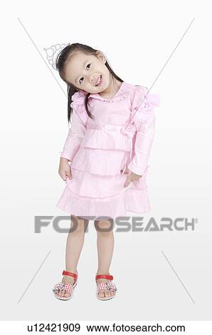 Little girl posing and looking away with smile View Large Photo Image Stock Photo - Little girl posing and looking away with smile. Fotosearch