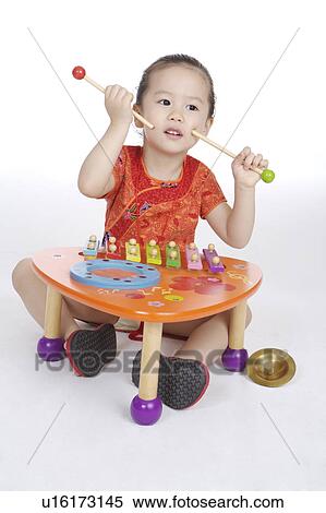 Little girl sitting and playing xylophone View Large Photo Image Stock Photography - Little girl sitting and playing xylophone. Fotosearch