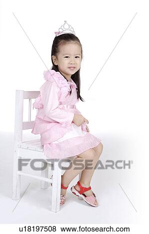 Little girl sitting on chair and smiling at the camera View Large Photo Image Stock Photo - Little girl sitting on chair and smiling at the camera. Fotosearch