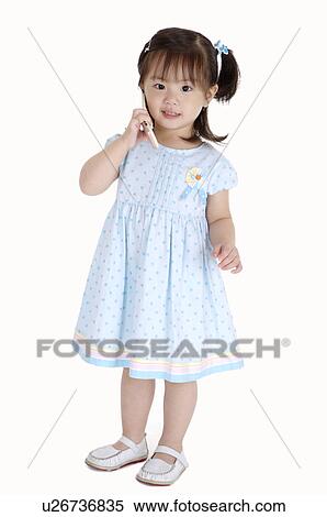 Little girl standing and holding mobile phone with smile View Large Photo Image Stock Photography - Little girl standing and holding mobile phone with smile. Fotosearch