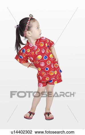 Little girl standing with arms akimbo and looking away View Large Photo Image Stock Image - Little girl standing with arms akimbo and looking away. Fotosearch