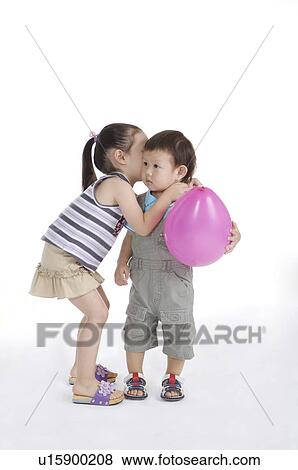 Little girl telling secret to little boy and standing together View Large Photo Image Stock Photo - Little girl telling secret to little boy and standing together. Fotosearch