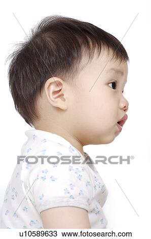 Stock Image - Portrait of baby boy looking away with mouth open. Fotosearch
