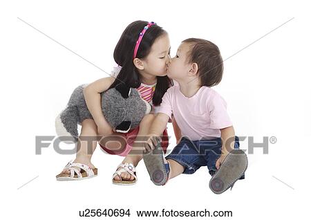 Picture - Two children sitting and kissing together. Fotosearch