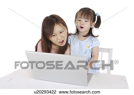 Young mother and little girl using laptop, reading and singing together View Large Photo Image Stock Image - Young mother and little girl using laptop, reading and singing together. Fotosearch