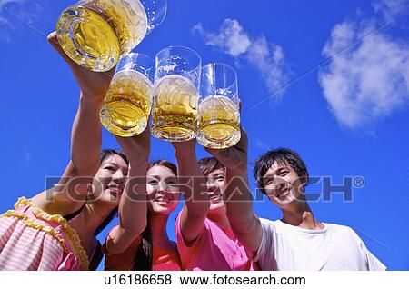 Four people holding beer for celebrating and smiling, View Large Photo Image Stock Photo - Four people holding beer for celebrating and smiling,. Fotosearch