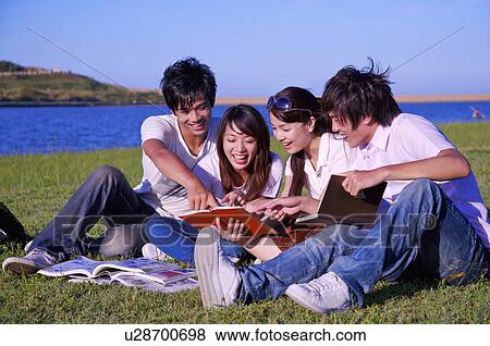 Four people sitting on the lawn and reading books with smile together, View Large Photo Image Stock Photo - Four people sitting on the lawn and reading books with smile together,. Fotosearch