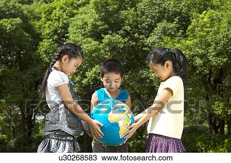Three children holding the globe together and looking down, Child, View Large Photo Image Stock Image - Three children holding the globe together and looking down, Child,. Fotosearch