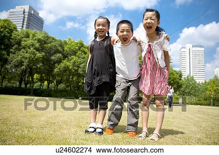 Three children standing in a row with arms around and shouting with mouth open View Large Photo Image Picture - Three children standing in a row with arms around and shouting with mouth open. Fotosearch