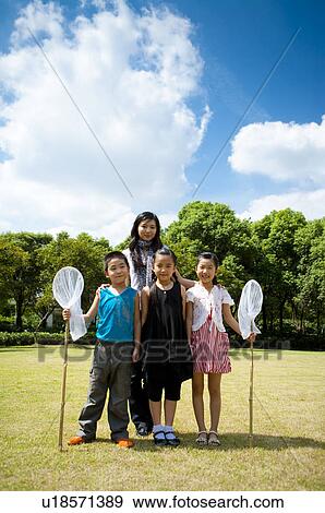 Young woman and children standing together and holding butterfly nets View Large Photo Image Stock Photo - Young woman and children standing together and holding butterfly nets. Fotosearch