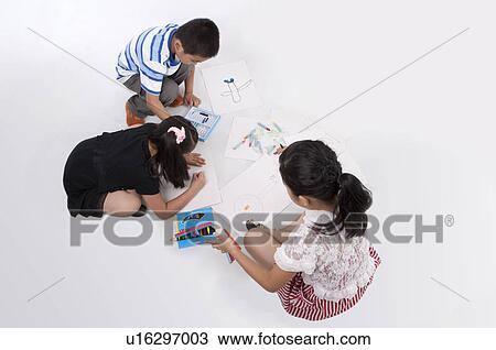 Stock Image - Child, Children drawing and looking down together. Fotosearch