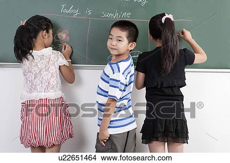 Child, Children drawing on the blackboard View Large Photo Image Picture - Child, Children drawing on the blackboard. Fotosearch
