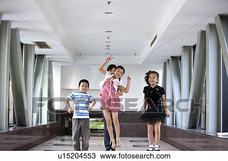 Child, Children jumping on the corridor with teacher standing behind View Large Photo Image Stock Image - Child, Children jumping on the corridor with teacher standing behind. Fotosearch