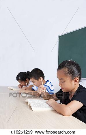 Stock Photo - Child, Children sitting and studying in the classroom. Fotosearch