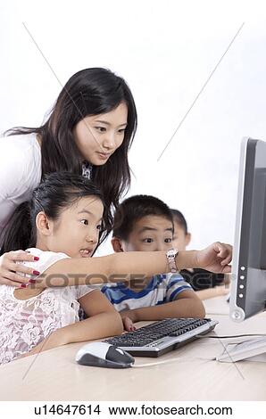 Child, Children studying and looking at the computer with their teacher View Large Photo Image Picture - Child, Children studying and looking at the computer with their teacher. Fotosearch