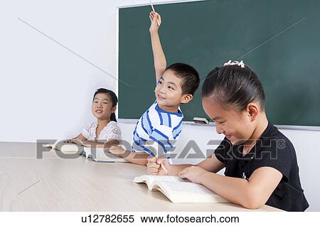 Stock Photography - Child, Children studying and raising hand in the classroom. Fotosearch