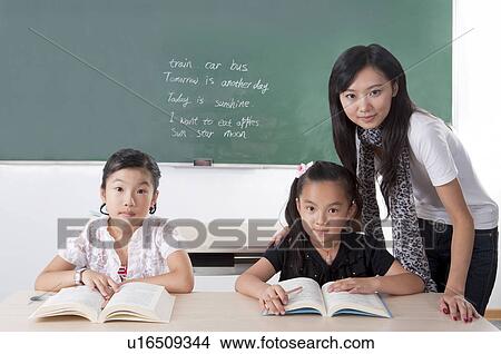Child, Children studying in the classroom and looking at the camera with teacher View Large Photo Image Picture - Child, Children studying in the classroom and looking at the camera with teacher. Fotosearch