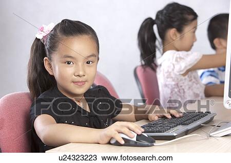 Child, Children using computer and looking at the camera with smile View Large Photo Image Stock Image - Child, Children using computer and looking at the camera with smile. Fotosearch