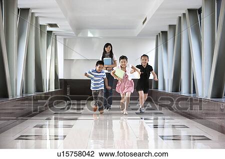 Child, Four children running on the corridor with their teacher View Large Photo Image Stock Image - Child, Four children running on the corridor with their teacher. Fotosearch