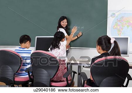 Child, Young teacher teaching three children and smiling View Large Photo Image Stock Photograph - Child, Young teacher teaching three children and smiling. Fotosearch