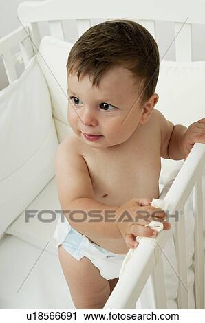Baby boy in crib View Large Photo Image Stock Image - Baby boy in crib. Fotosearch