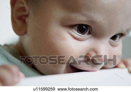 Stock Photo - Closeup of baby boy in crib. Fotosearch