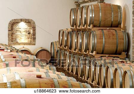 Stock Image - Barrels of wine in a cellar. Fotosearch