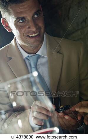 Stock Image - Young man with a ring and young woman's hand. Fotosearch