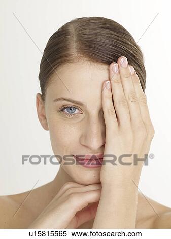 Woman is putting hand on her face View Large Photo Image Stock Photography - Woman is putting hand on her face. Fotosearch