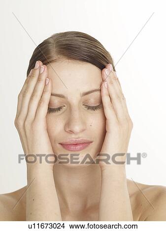 Woman is putting hands on her face View Large Photo Image Picture - Woman is putting hands on her face. Fotosearch