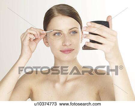 Woman twitching her eyebrows View Large Photo Image Stock Image - Woman twitching her eyebrows. Fotosearch