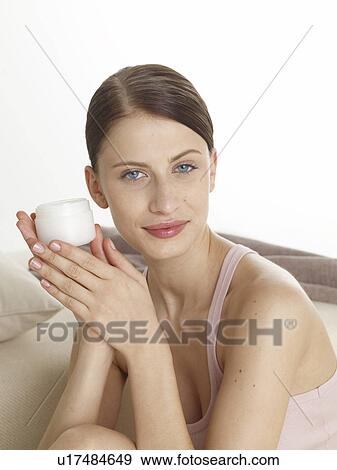 Stock Photo - Woman with a cream pot. Fotosearch