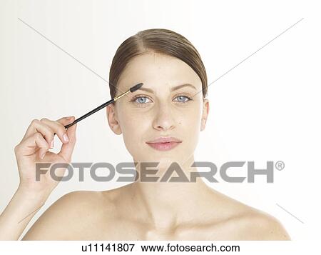 Woman with a eyebrow building brush View Large Photo Image Stock Photo - Woman with a eyebrow building brush. Fotosearch