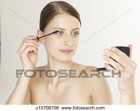 Woman with a lash brush View Large Photo Image Stock Photo - Woman with a lash brush. Fotosearch