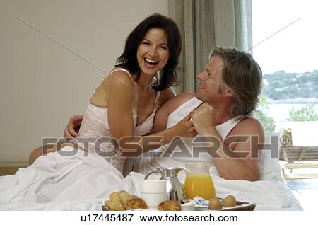 Stock Photo - Couple is having breakfast in bed. Fotosearch