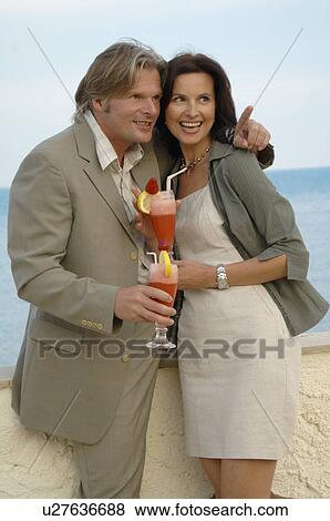 Woman at the sea with cocktails View Large Photo Image Stock Photo - Woman at the sea with cocktails. Fotosearch