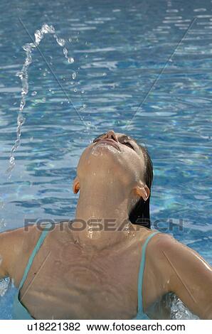 Stock Image - Woman is spitting water. Fotosearch