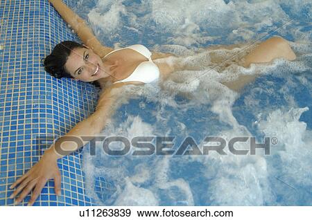 Woman lying in a swimming pool View Large Photo Image Stock Photo - Woman lying in a swimming pool. Fotosearch