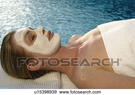 Stock Photo - Woman with a facial mask. Fotosearch
