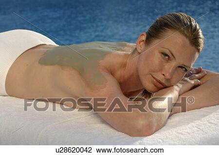 Stock Image - Woman with a fango poultice on her back. Fotosearch