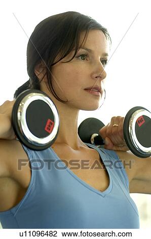 Stock Image - Woman with barbells. Fotosearch